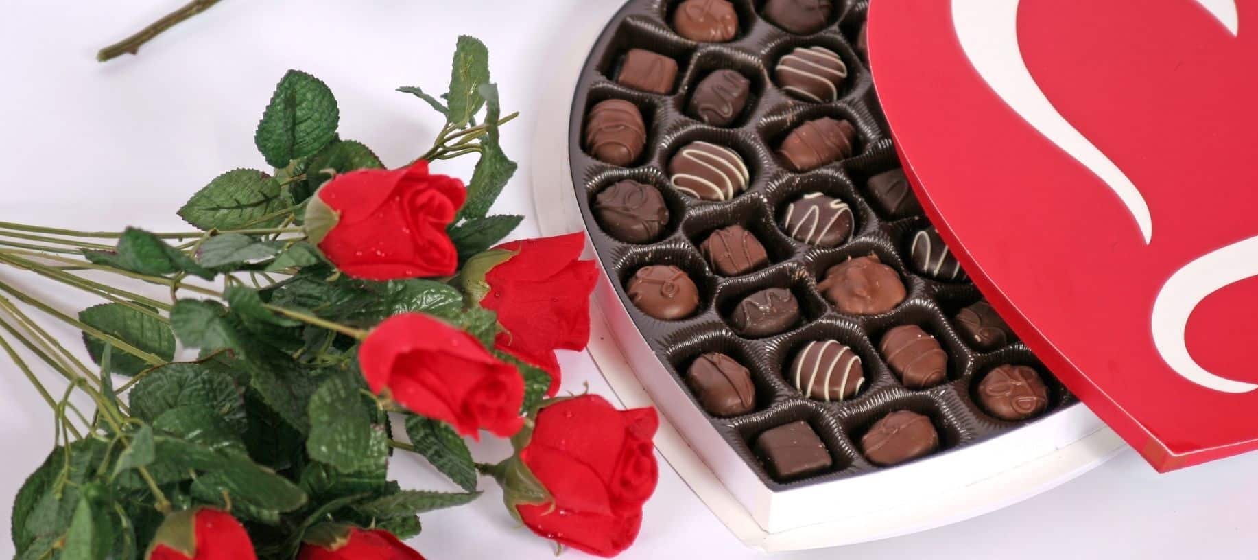 Heart shaped box with chocolates and red roses