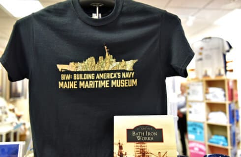 Black t-shirt and book for sale im Maine museum gift shop