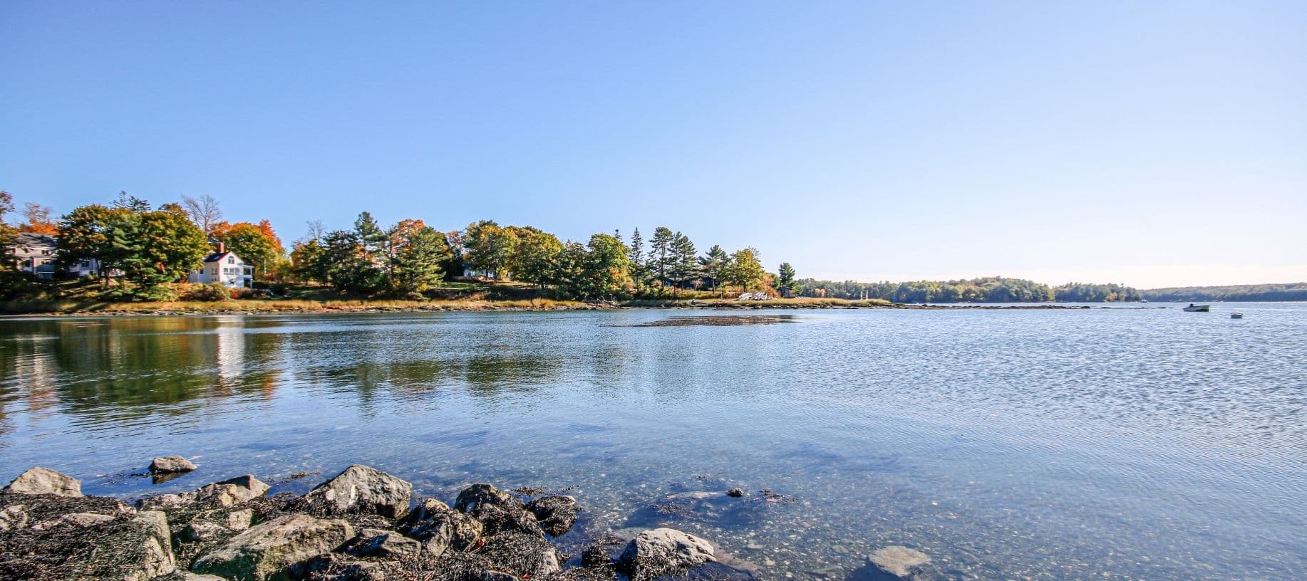 Damarascotta River in the fall with tree and rocklined shores